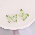Gold butterfly earrings with green zircon and 925 silver needles on a white tray - Green
