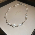 Detailed shot of pearl and irregular silver bead necklace with star-shaped light reflections - Crushed Silver Pearl Irregular Splicing Necklace