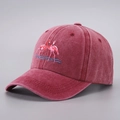 Washed burgundy baseball cap featuring pink flamingo embroidery and adjustable brim - Burgundy