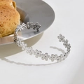Polished silver floral pattern open bangle with continuous small flower motifs - Silver Hollow Flower