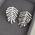 Silver palm leaf earrings with hammered texture finish in a purple velvet jewelry box - Silver