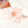 Close-up of a pearlescent pink gradient flower hair claw clip with smooth edges - Pearlescent Orange