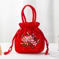 Handcrafted bright red satin handbag with floral embroidery and tassel drawstring - Red