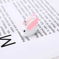 Close-up of a white resin rabbit charm with pink ears and a silver metal hanging loop - Little Rabbit