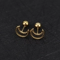 Macro shot of 16G gold crescent moon cartilage studs with screw ball backs - Hollow Moon and Star Necklace / Gold