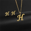 Close-up of golden stainless steel H-letter pendant necklace and stud earrings set - Letter H / Gold