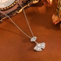 Macro view of silver ginkgo leaf pendant with pearls and crystals on textured background - Silver Maple Leaf Pearl Style (T029)