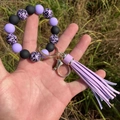 Detail of beaded silicone keychain wristlet with purple leopard pattern and leather tassel - Taro Purple