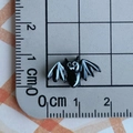 Close-up of a 1.5cm black resin bat bead on a scale mat for DIY crafts decoration - Black Bat