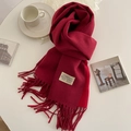 Solid red cashmere-feel scarf with fringe and gold label on a minimalist white table - 200x68cm / Bright Red Wine