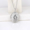 Silver oval locket necklace with floral engraving and cross chain on white marble background - Oval Peach Blossom/Steel