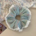Close-up of rainbow knit scrunchie with white lace trim on a minimalist background - Lace Rainbow Blue