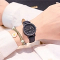 Close-up of minimalist black leather watch worn with a white daisy floral charm bracelet - Black