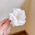 Elegant white mesh flower hair clip with layered petals and yellow stamen detail - White Camellia