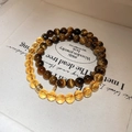Detailed macro of crystal beaded bracelets with golden charms in a premium white gift box - 22# Coin Citrine Tiger Eye Bracelet - Gift Box