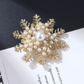 Snowflake brooch with white pearls on a gold base against a modern contrast background - XZ4028 Snowflake Radial