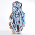 Blue paisley square satin scarf with red floral pattern styled on a mannequin head - Light Blue