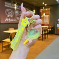 Close-up of yellow Sakura lollipop keychain with glitter filled acrylic ball and strap - Yellow Luminous Bubble Bead Lollipop