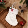 White cable knit Christmas stocking with red embroidered letter W and festive berries - Letter W