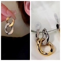 Detail of two-tone chain link drop earrings with gold and silver polished metal finish - Chain Clip-on Style