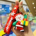 Close-up of a Santa Claus keychain with red rubber strap and golden metal buckle - Gift Santa
