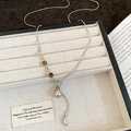 Detail of silver snake chain necklace with tiger eye bead and drop pendant in a beige box - Silver Tiger Eye Beaded Teardrop Necklace