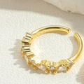 Detailed shot of adjustable gold-plated ring featuring sparkling cubic zirconia stones - Pear and Round Zirconia Inlay