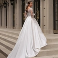 Elegant ivory backless wedding gown with lace sleeves and long satin train on stairs - US 2 / Ivory