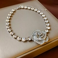 Macro detail of silver-toned necklace featuring a sparkling crystal-studded rose pendant - Silver Tone Rhinestone Rose Pendant Necklace