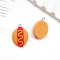 Miniature resin hot dog charms with yellow mustard and red sausage details - Hotdog