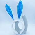 Blue sequin rabbit ear headband with white plush trim on a decorative vase display - Blue Fluorescent Bunny