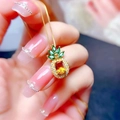 Close-up of a golden necklace with a pineapple pendant featuring yellow and green gemstones - Pendant Only (No Chain)