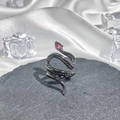 Detail of snake ring with red gemstone eye on dark grey stone and white silk background - Style 11 Adjustable Ring
