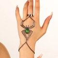 Gothic spider bracelet with green gemstone for Halloween, shown on hand with black metal finish - Green Spider Hand Chain (11407)