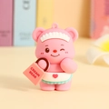Pink Cream Bear keychain figurine in maid outfit with a mint green skirt and orange bag - Pink Handbag Ornament