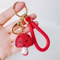 Detail of red resin mushroom keychain with sparkling rhinestones and woven wrist strap - Mushroom + Heart Strap / Red