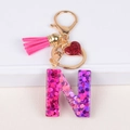 Letter N resin keychain with pink glitter, leather tassel and red heart charm pendant - Letter N