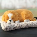 Detailed close-up of a realistic plush puppy sleeping on a soft grey cushion outdoors - Large Golden Retriever Dog