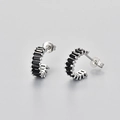 Macro view of 925 sterling silver hoop earrings set with square black zircon stones - White Gold / Black Zircon