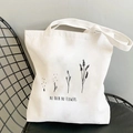 Detail of white canvas tote bag with 'NO RAIN NO FLOWERS' print and plant line art - Quote & Flower 1-R29