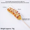 Realistic artificial corn dog model with breadcrumbs and sauce drizzled on top - Colorful Cream Cheese Hot Dog Stick