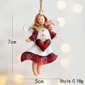 Detail view of resin angel ornament with red heart and twine, 7cm height dimensions - Style C Red Dress with Heart