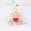Detail showing a golden pumpkin carriage keychain with red heart and clear rhinestones - Red