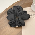 Elegant black satin scrunchie with premium silk texture and a gold metal charm detail - Black
