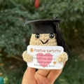 Close-up of handmade crochet positive potato with black graduation cap and card - Doctor Hat Potato