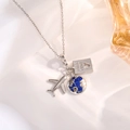 Detailed view of travel charms including silver airplane, globe, and passport on a fine chain - Silver Airplane Heart Passport Style B