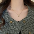 Close-up of a gold chain necklace with round pendant worn on a model's neck - 32# Necklace-Gold-Round