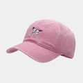 Close-up of detailed black and white dog embroidery on washed pink cotton baseball cap - Pink