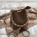 Dark brown bucket bag in matte leather featuring a gold chain handle and shoulder strap - Coffee