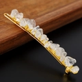 Detailed macro view of handmade gold wire wrapped clear crystal stones on hair clip - Clear Quartz + Gold Clip